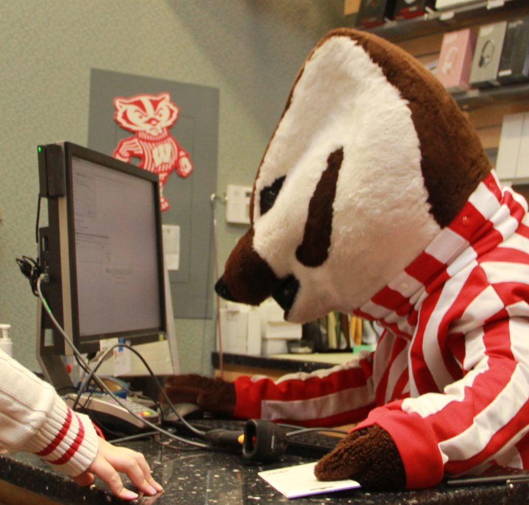 Bucky the Badger stares intently at a computer while completing some digital task.