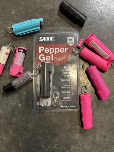 Small collection of multi-colored pepper spray and gel canisters.